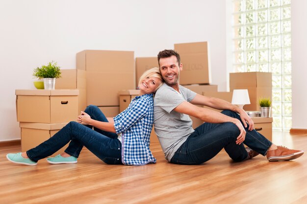 Loving couple sitting in their new apartment