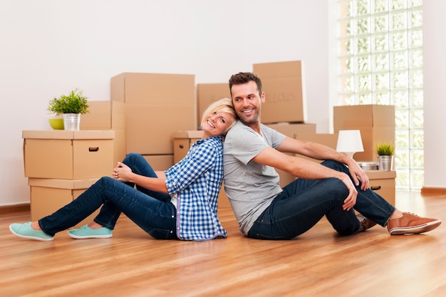 Loving couple sitting in their new apartment