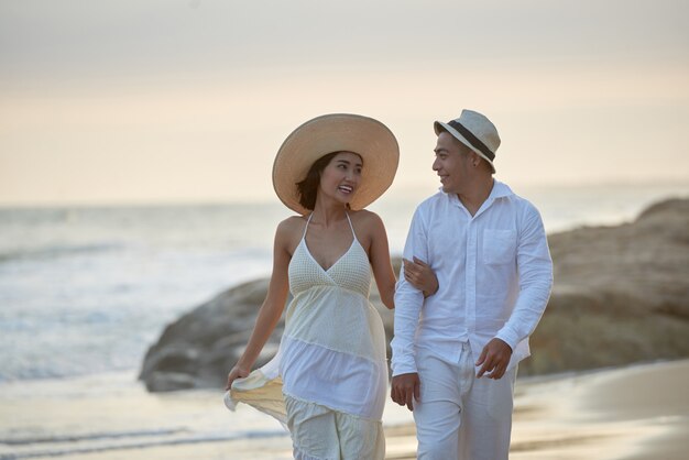 Loving Couple Walking Along Seashore