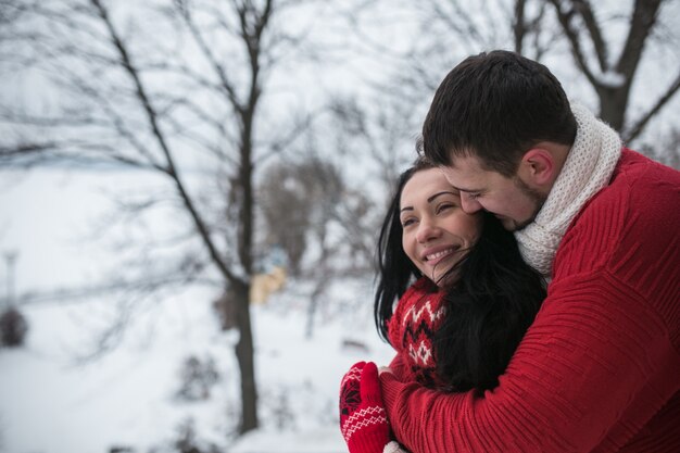 Loving couple in warm clothing outside