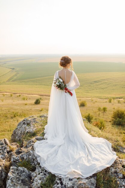 Loving couple wedding newlyweds outside at sunset in beautiful summer day