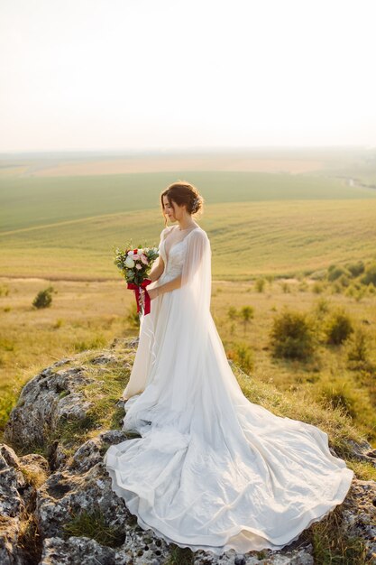 Loving couple wedding newlyweds outside at sunset in beautiful summer day