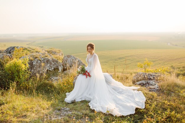 Loving couple wedding newlyweds outside at sunset in beautiful summer day