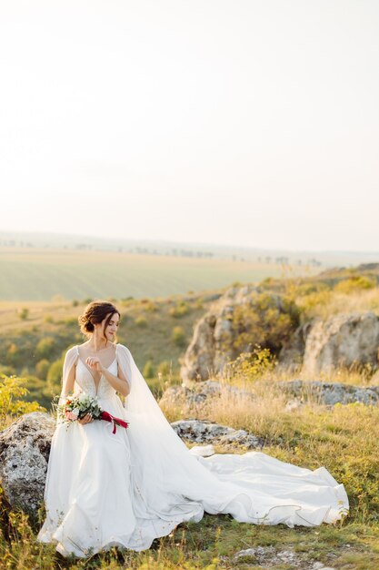 Loving couple wedding newlyweds outside at sunset in beautiful summer day