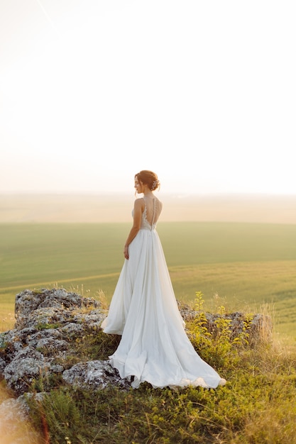 Free photo loving couple wedding newlyweds outside at sunset in beautiful summer day