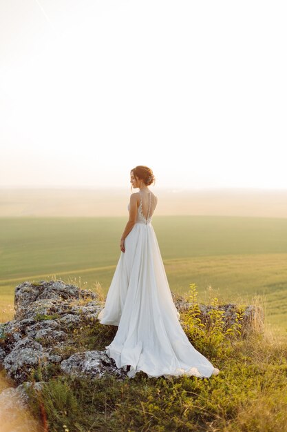 Loving couple wedding newlyweds outside at sunset in beautiful summer day