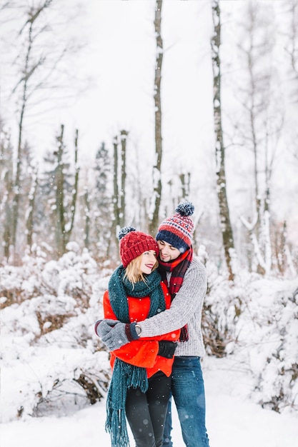 Loving couple in winter magical woods