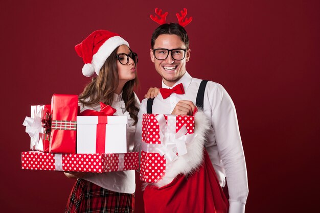 Loving couple with a lot of christmas gifts