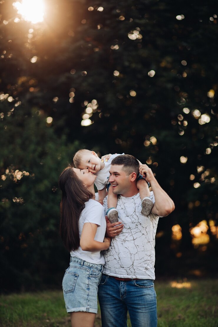 Free Photo loving family with baby son in park.