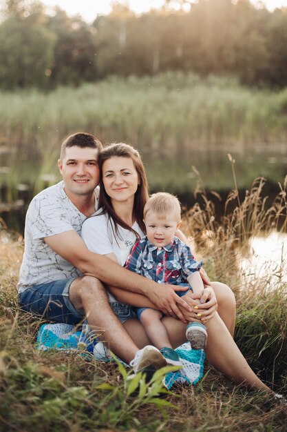 Free photo loving family with baby son in park.