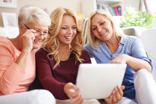 Loving family of women using digital tablet