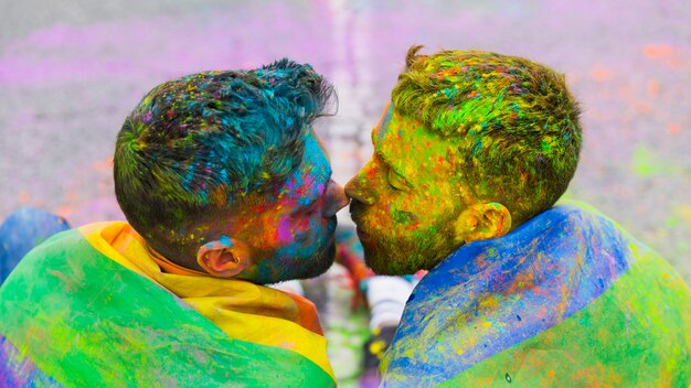 Loving gay couple gathered kissing
