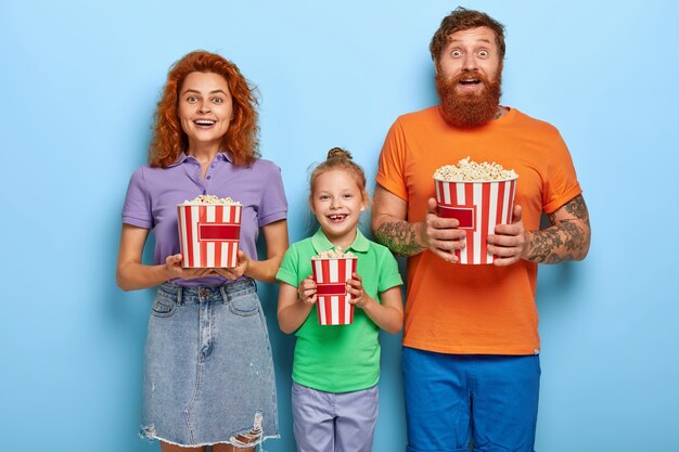 Loving ginger family posing with popcorn