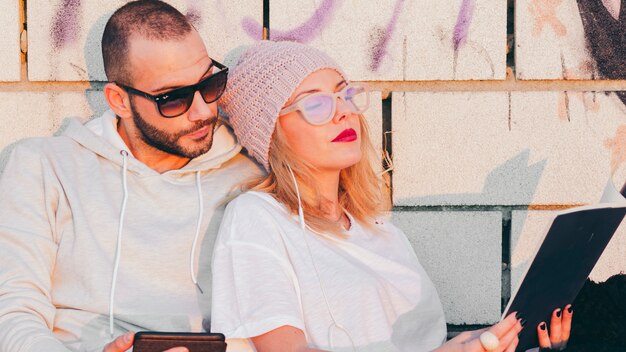 Loving hipster couple relaxing outside