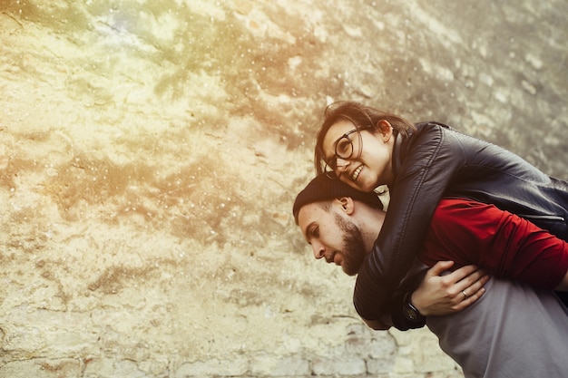 Loving man piggybacking his girlfriend