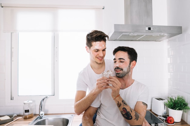 Free photo loving men making cookies together