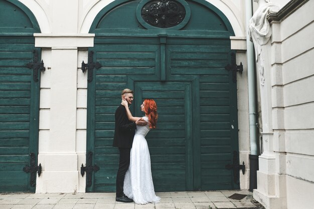 Loving newlyweds with a wooden door background