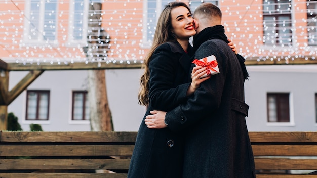 Free photo loving woman with present embracing man