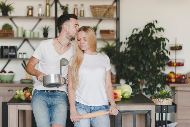 Loving young couple standing in the front of kitchen counter