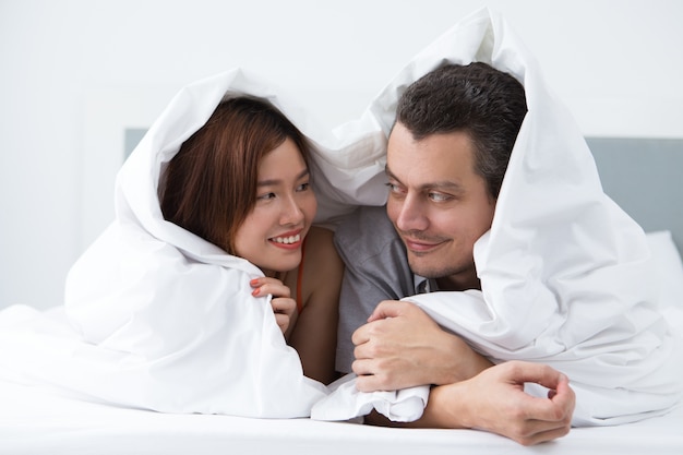 Loving young newlyweds resting in hotel room