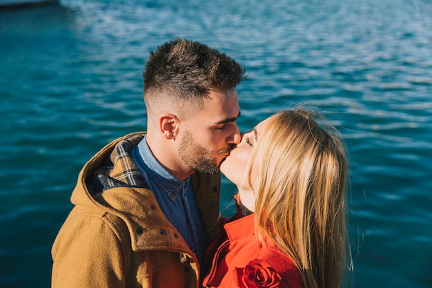 Free photo loving young people kissing happily