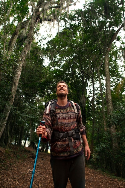 Free photo low angle adventurous man bivouacking