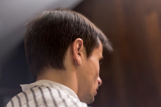 Low angle back view man at barbershop