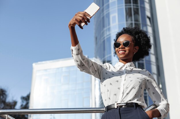 Low angle beautiful female taking selfies