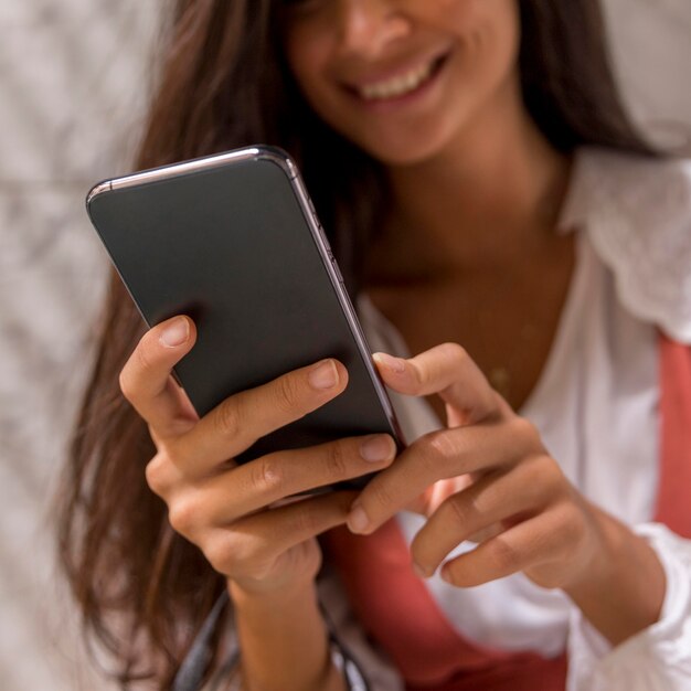 Low angle of beautiful woman with smartphone