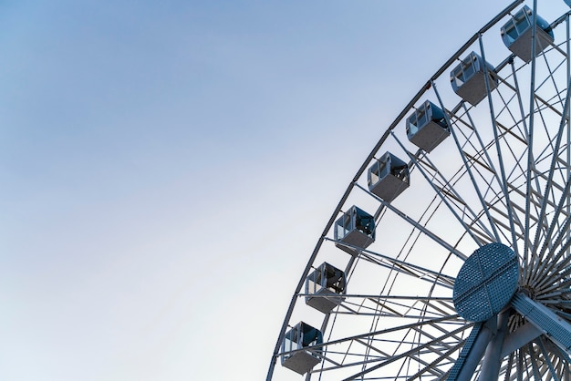 Low angle of big ferry wheel in the city with copy space