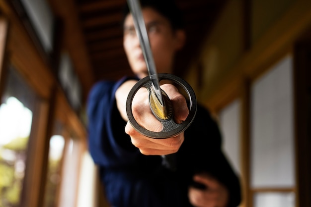 Low angle blurry man holding sword