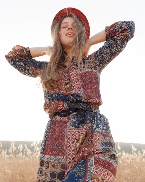 Free photo low angle of bohemian woman posing