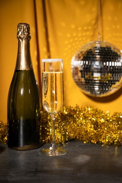 Free photo low angle bottle with champagne on table