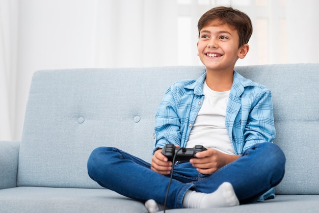 Low angle boy playing with joystick