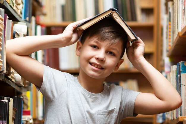 Low angle boy with book on head