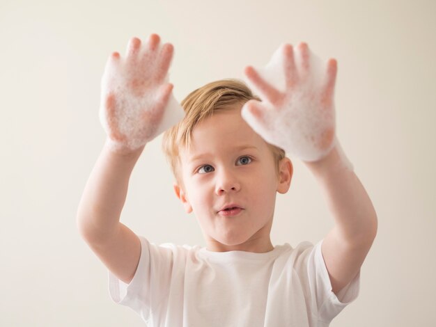 Low angle boy with foam on hands