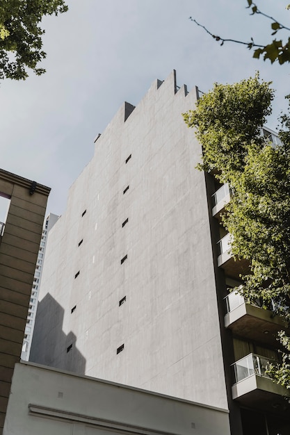 Low angle of building in the city with trees