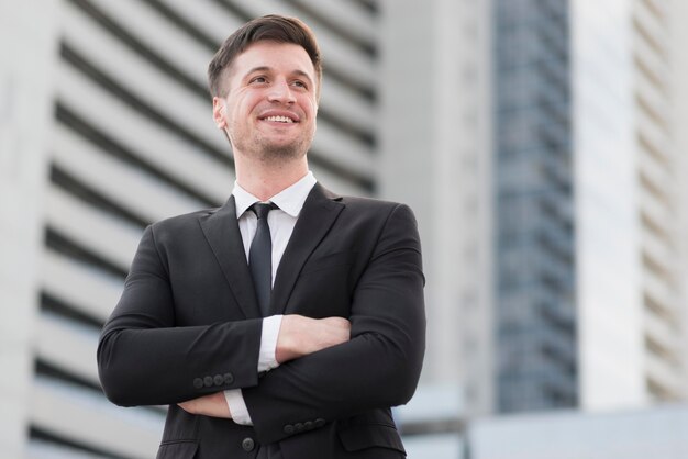 Low angle business man with arms crossed