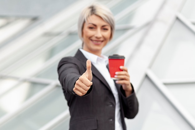 Low angle business woman showing ok sign