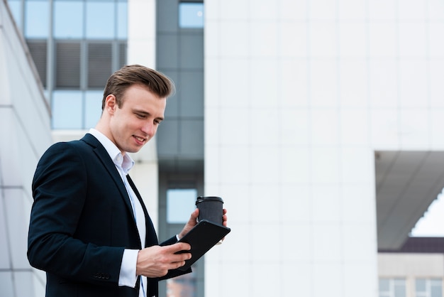 Low angle businessman using tablet