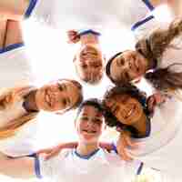 Free photo low angle children in sportswear looking down