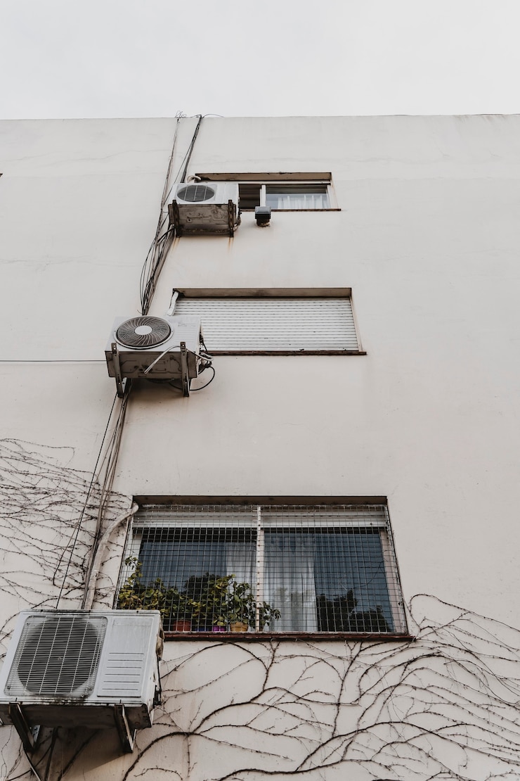 Free Photo low angle of city building with air conditioning units