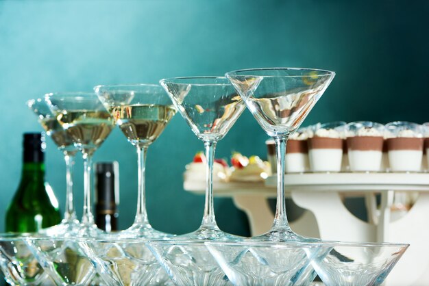 Low angle close up shot of martini glasses on the party table at the restaurant dinnerware glassware alcohol festive celebration drinks beverages mood.