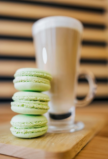 low angle of coffee beverage with macarons