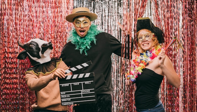 Free photo low angle costumed friends at carnival party