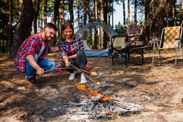 Low angle couple camping and cooking