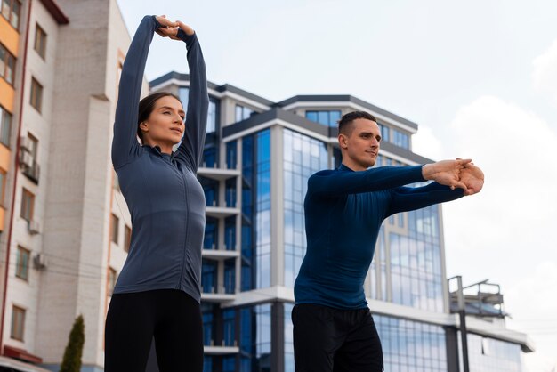 Free photo low angle couple doing workout exercises