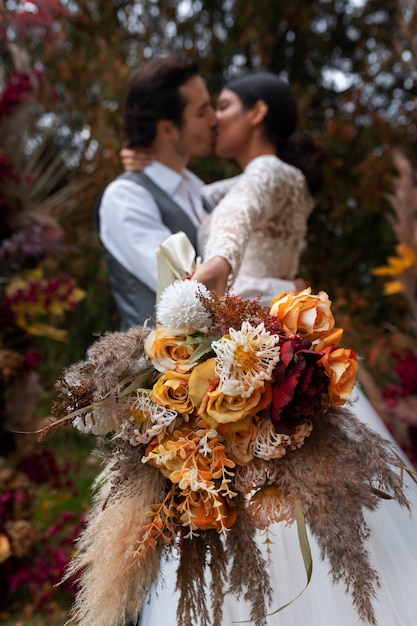 Free photo low angle couple kissing outdoors