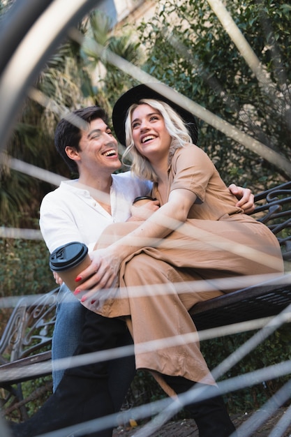 Low angle of couple seen through bicycle spokes