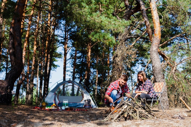 Free photo low angle couple with tent camping over night